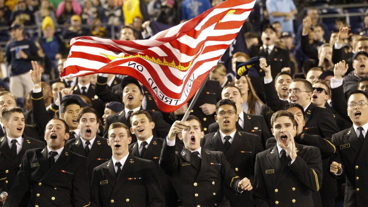 Navy midshipmen sing for their team at the San Diego Credit Union Poinsettia Bowl in San Diego in 2014.