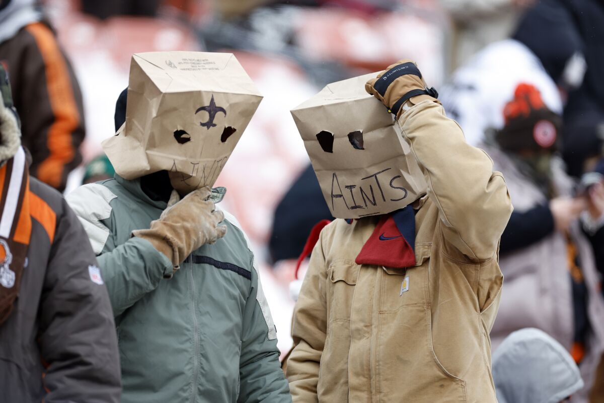 New Orleans Saints fans wear paper sacks over their heads.