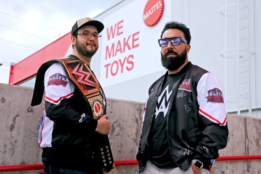Bruce Reyes, 33 of Downey, left, and George Martinez, 36 of Lennox, right, design WWE figures packaging for Mattel, at the Mattel Design Center in El Segundo on Friday, April 14, 2023.