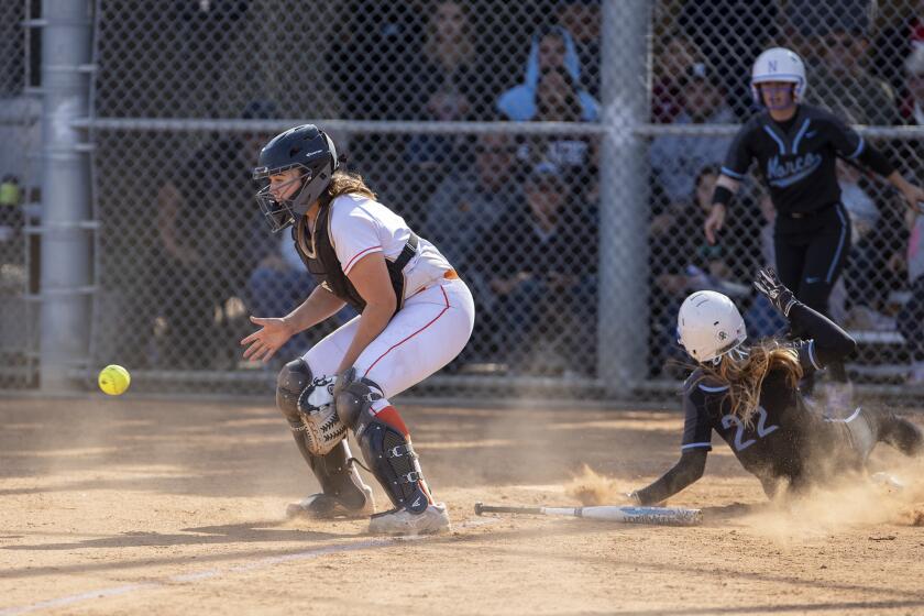 Norco High's Raegan Cheyne scores after beating the throw to Huntington Beach catcher Reanna Rudd on a single from Sarah Willis during the CIF Southern Section Division 1 semifinal playoff game on Tuesday.
