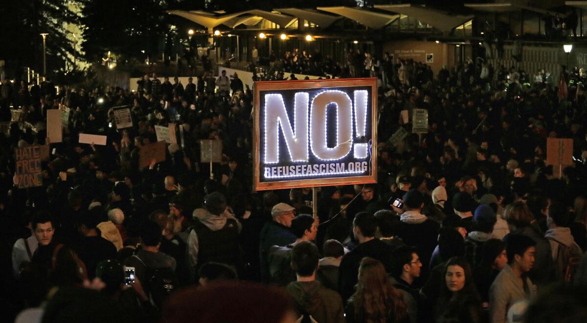 Demonstrators protest at UC Berkeley's Sproul Plaza against a scheduled appearance by Breitbart's Milo Yiannopoulos.