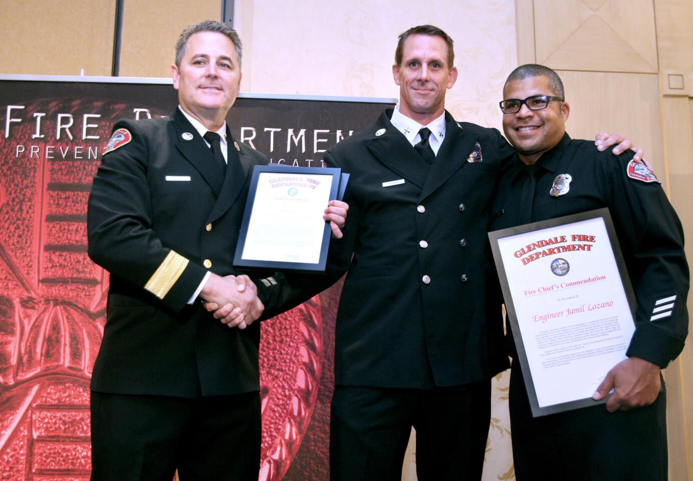 Glendale Fired Dept. chief Greg Fish, left, with Unit Citations winners T26/C Captain Todd Tucker, center, and engineer Jamil Lozano, right, at the annual City of Glendale Fire Department Awards Luncheon at the Hilton in Glendale on Wednesday, October 7, 2015. Lozano also got the Fire Chief's Commendation.