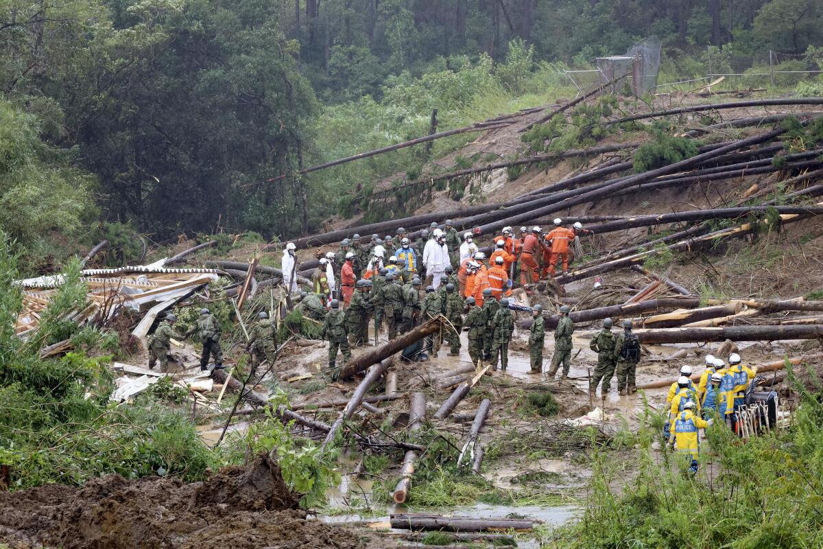 Rescue workers at the site of a landslide in southern Japan