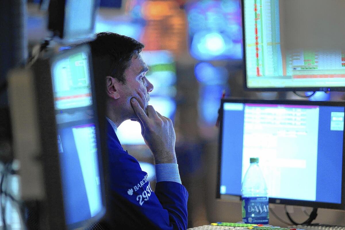 A trader watches a screen on the floor of the New York Stock Exchange on Tuesday.
