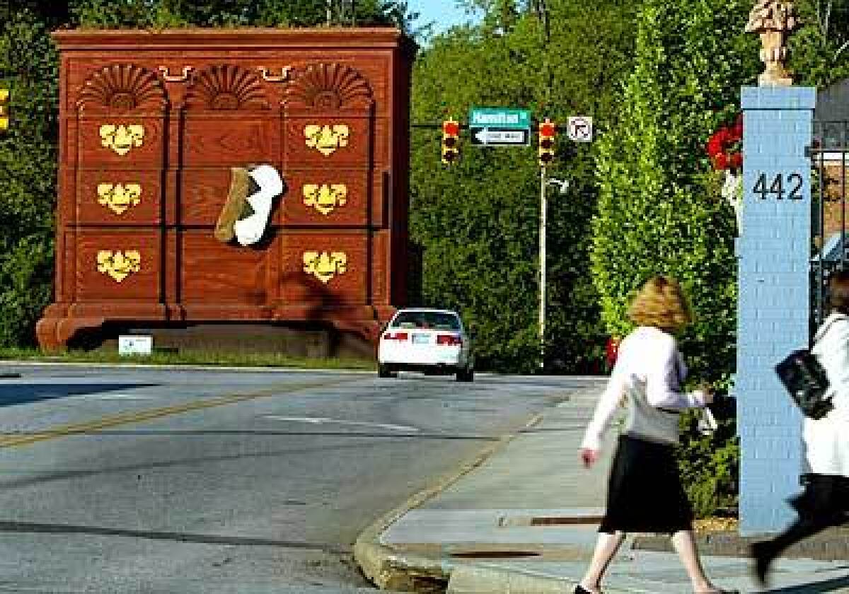 The worlds largest chest of drawers, a landmark in downtown High Point, stands 3 1/2 stories tall.