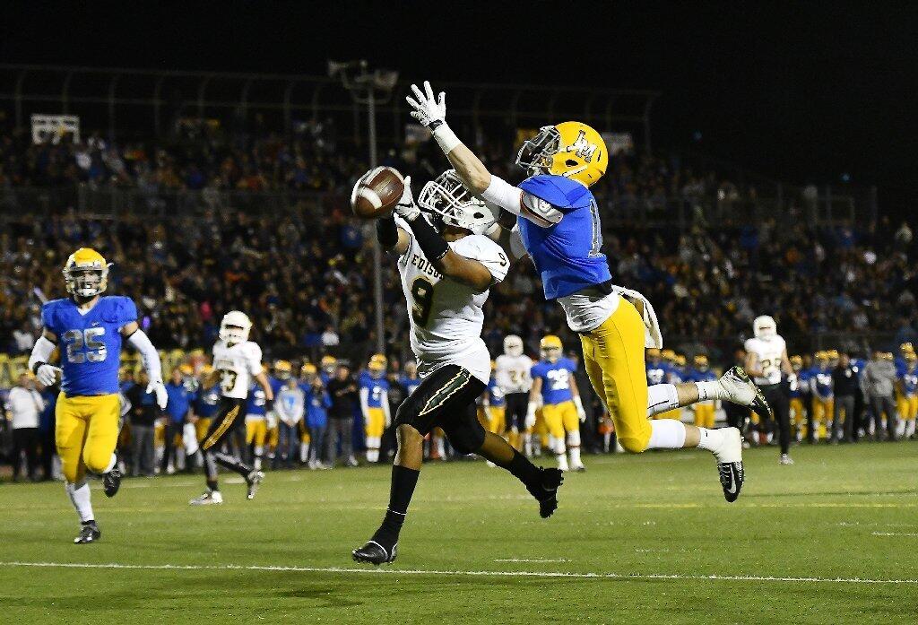 Edison's Chad Fisser just misses a pass over a La Mirada defender during the CIF Southern Section Division 3 championship game at La Mirada High School on Friday.