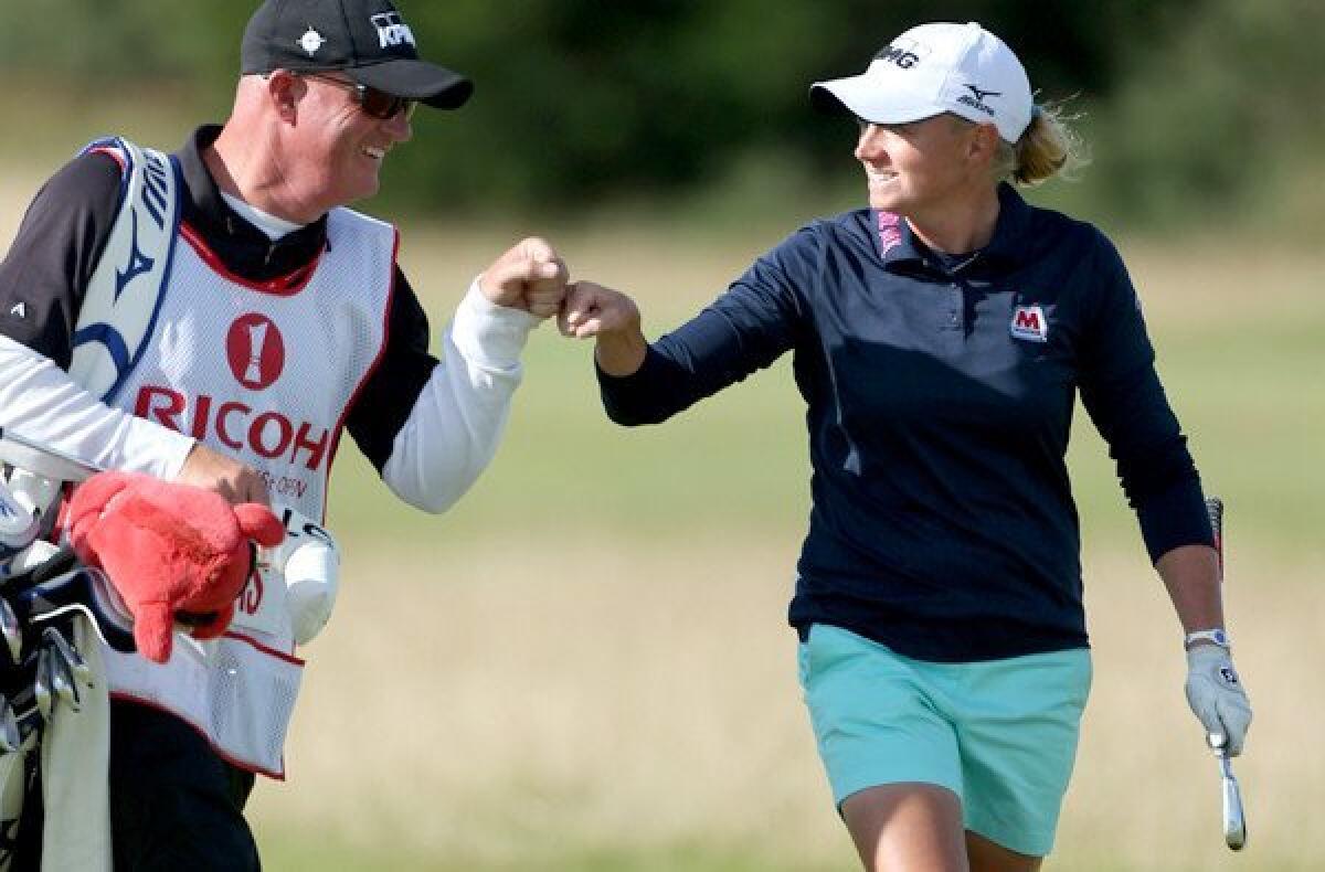 Stacy Lewis celebrates a shot with caddie Travis Wilson on the 17th hole during the final round of the Ricoh Women's British Open on Sunday at the Old Course in St Andrews, Scotland.