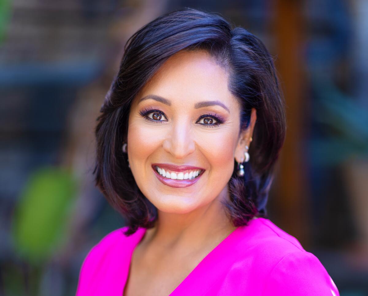 A portrait of a woman with dark hair smiling