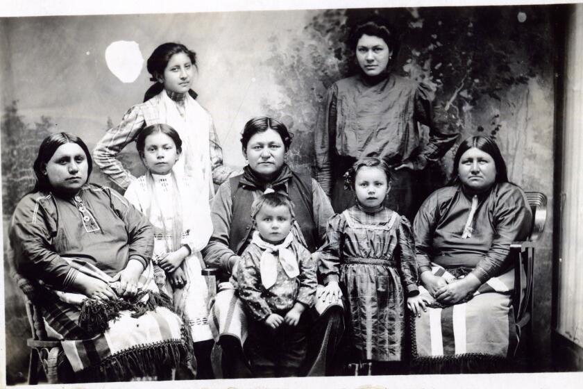 Postcard features a photograph of a group of unidentified women and children of the Osage Nation, Pawhuska, Oklahoma Territory, circa 1918 - 1922. (Photo by William J Boag/Oklahoma Historical Society/Getty Images)