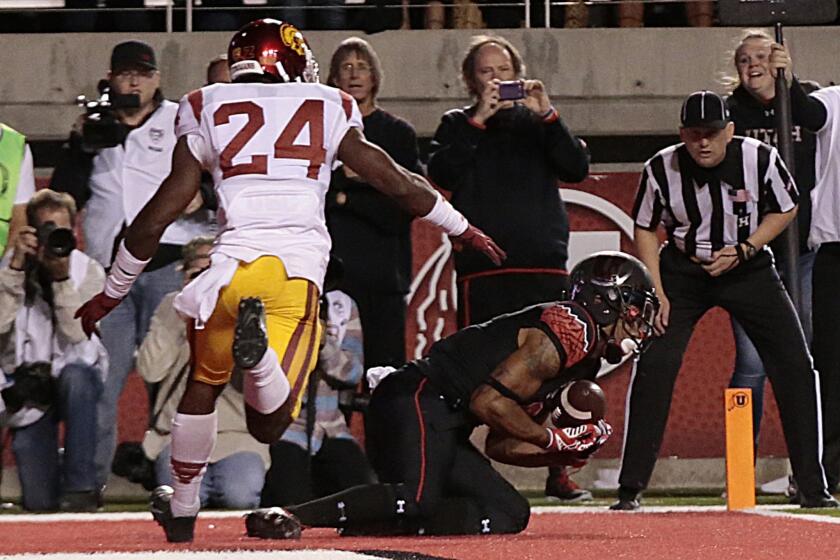 Utah receiver Kaelin Clay hauls in the game-winning, one-yard touchdown catch against cornerback John Plattenburg and USC with eight seconds left.