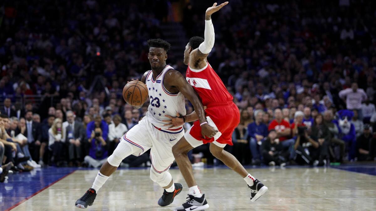 Philadelphia 76ers' Jimmy Butler, left, tries to get past Toronto Raptors' Patrick McCaw during the first half of Game 6 of a second-round NBA playoff series on Thursday in Philadelphia.