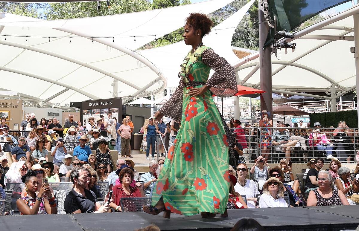 Model Valair Williams walks down the runway in a dress in honor of designer Ossie Clark.