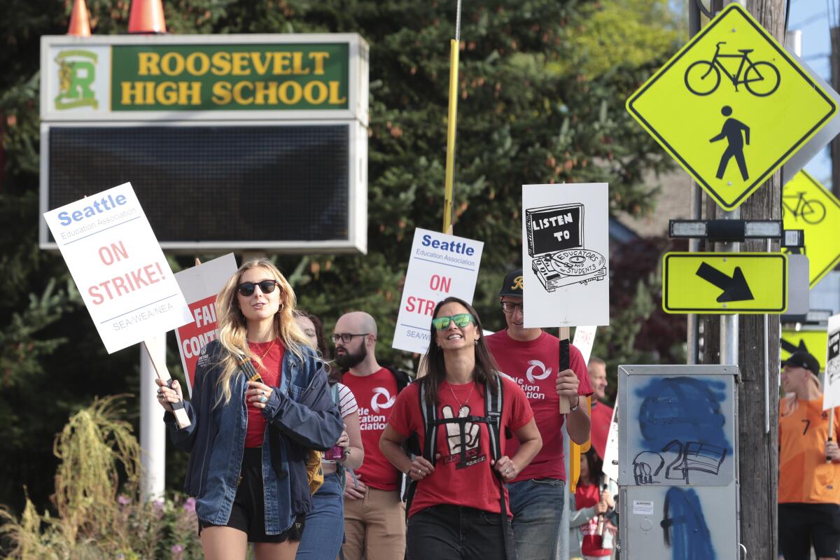 Teachers from Seattle Public Schools picket outside a high school.