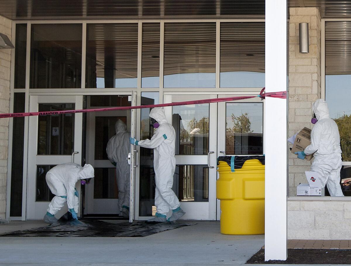 A hazardous materials crew works on disinfecting North Belton Middle School in Belton, Texas. The Central Texas school district has temporarily closed three campuses after a family from the district traveled on the same flight as Amber Vinson, a nurse who has since been diagnosed with Ebola.