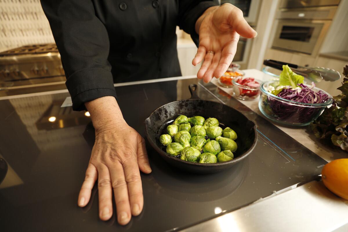 A chef demonstrates an induction cooktop in Van Nuys on Dec. 3.