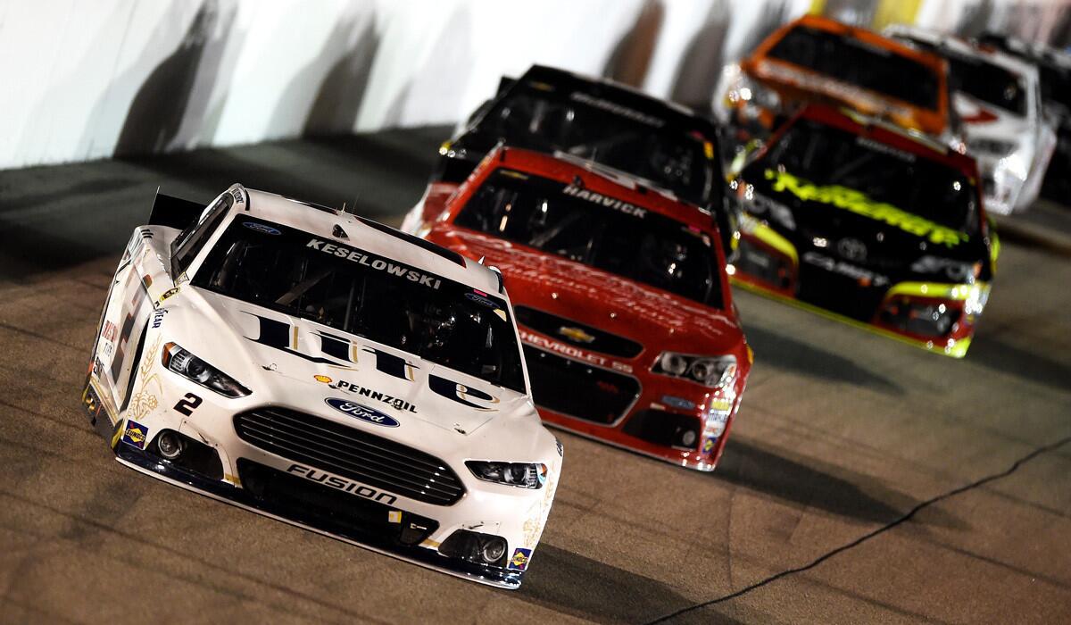 NASCAR driver Brad Keselowski, in the No. 2 Ford, leads a pack of cars during the NASCAR Sprint Cup Series Federated Auto Parts 400 at Richmond International Raceway on Saturday night.