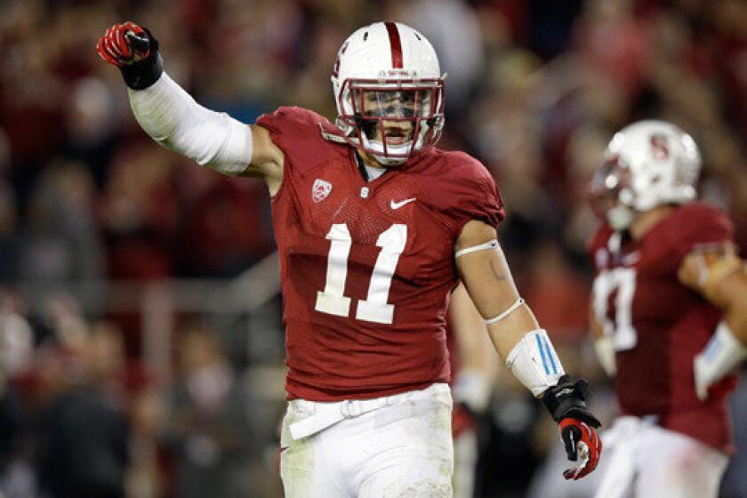Linebacker Shayne Skov of Stanford, which changed its nickname from Indians to Cardinal (as in the color), encourages the crowd to make noise during the fourth quarter of the Cardinal's 26-20 upset over Pac-12 rival Oregon on Thursday.