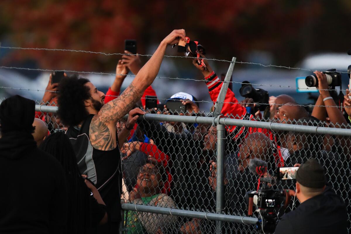 Colin Kaepernick interacts with fans and signs autographs.