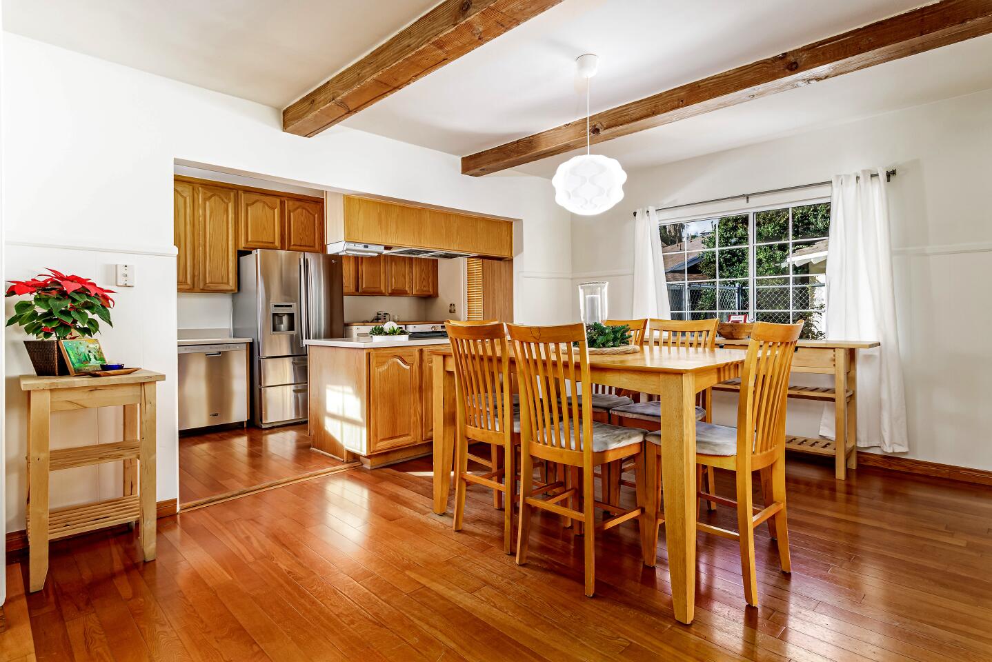 The $1.094-million home showcases sunny living spaces with wood floors.