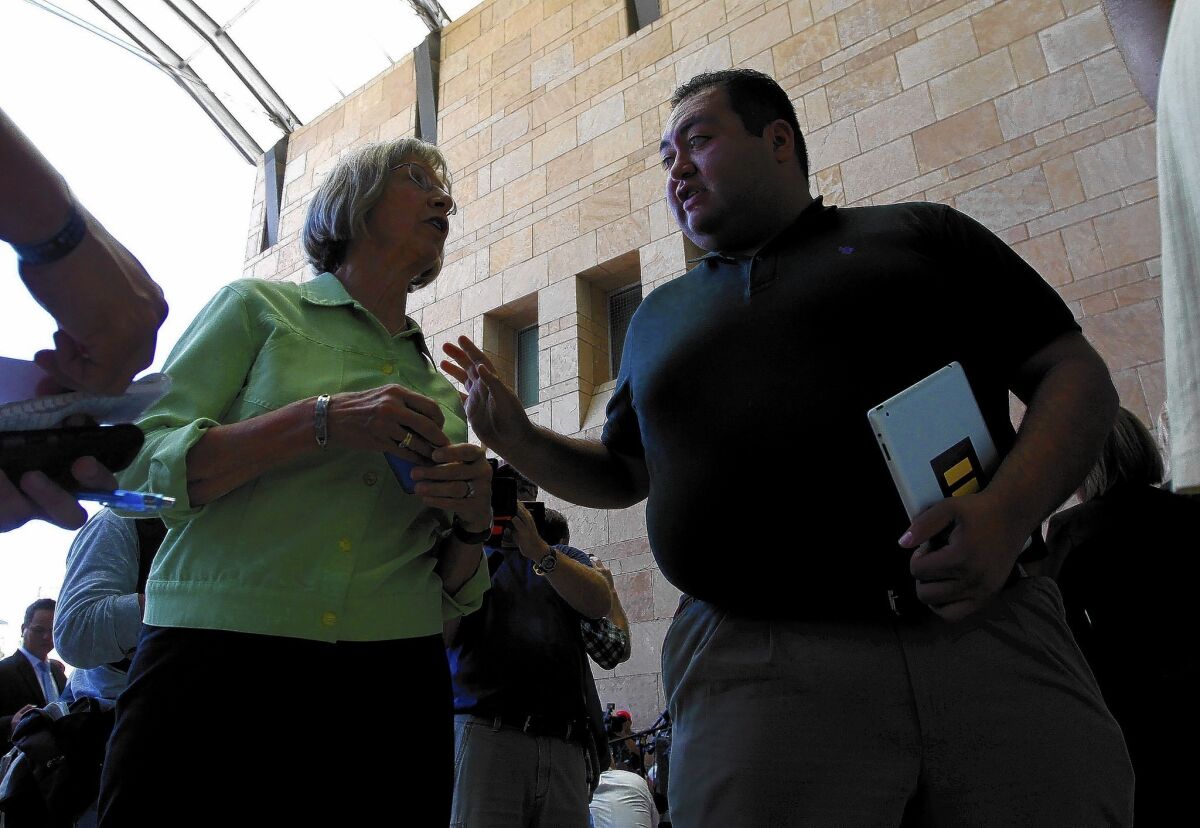 Daniel Hernandez Jr. speaks with Pam Simon, a former member of Rep. Gabrielle Giffords’ staff, in Tucson in 2012. Simon was one of the wounded in the 2011 shooting.