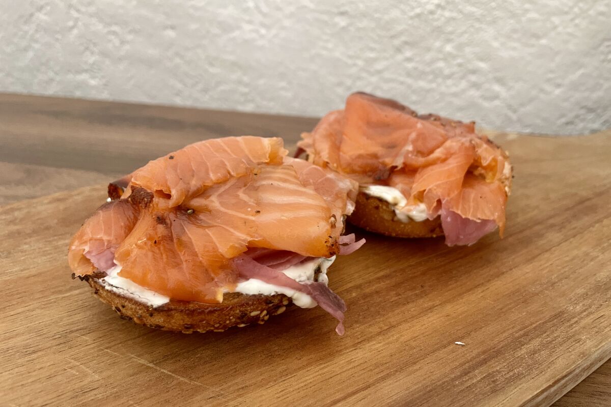 An everything bagel with pastrami lox, labneh and pickled onions.