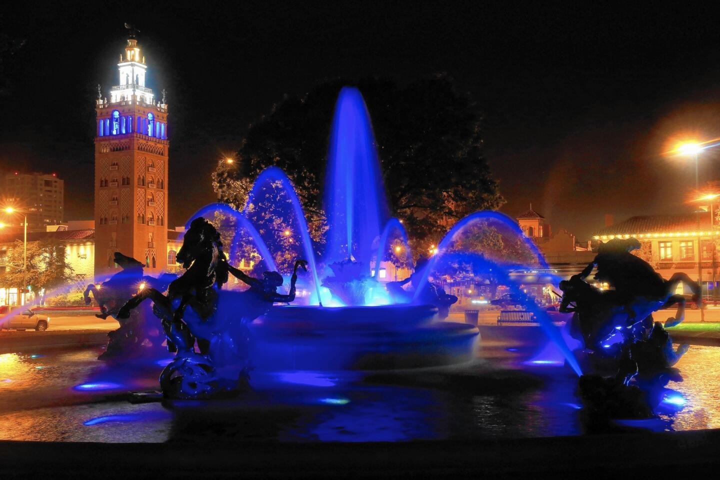 J.C. Nichols Memorial Fountain in Kansas City, Mo. sprays blue water in front of the Country Club Plaza in honor of the Kansas City Royals' World Series win in November. Fountains are ingrained in Kansas City’s identity and more than 200 throughout the city offer gurgling oases.