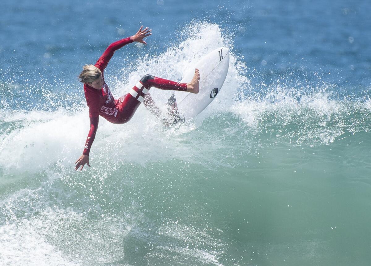 Nick Marshall of Encinitas rides a wave in round 4 of the men's open at the National Scholastic Surfing Assn. National Championships on Tuesday in Huntington Beach.