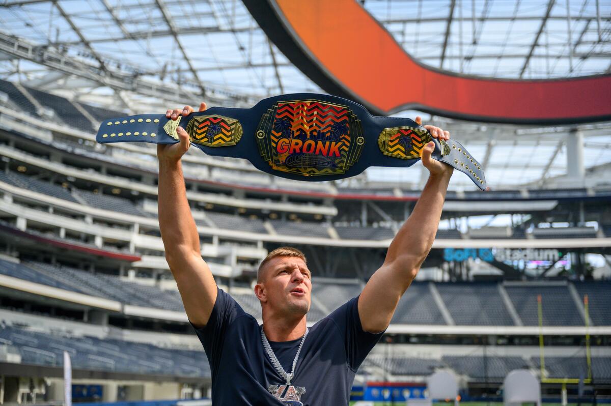 Former NFL tight end Rob Gronkowski holds a championship belt at SoFi Stadium.