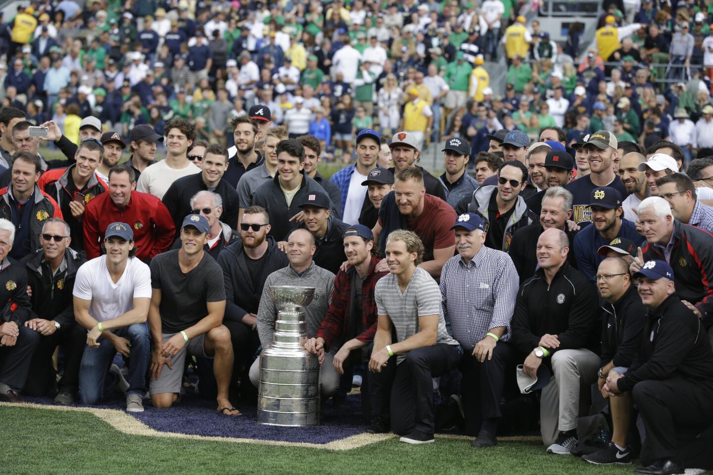 The Blackhawks pose with the Stanley Cup before the Notre Dame-Georgia Tech game in South Bend, Ind.