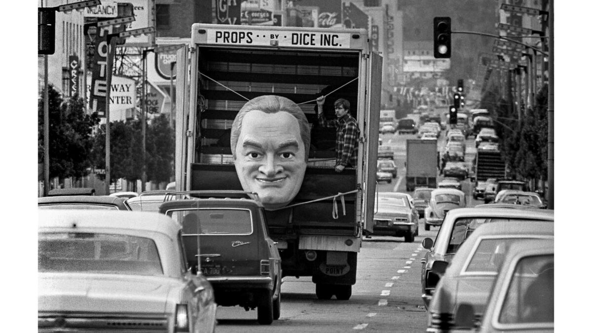Truck carrying bust of Bob Hope driving down Hollywood Boulevard