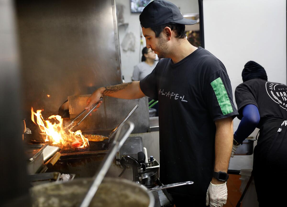 Kareem Hawari cooks at his family's restaurant, Kareem's Falafel, in Anaheim.
