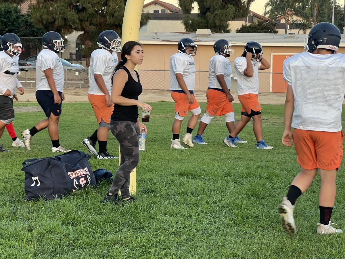 Chatsworth manager Aniela Valladares on the field with the football team.