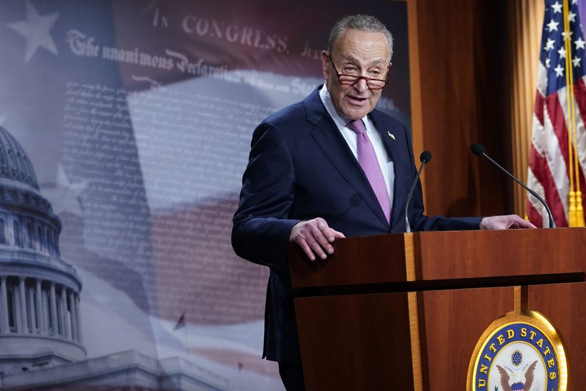 Sen. Charles Schumer speaks at a lectern bearing the United States Senate seal