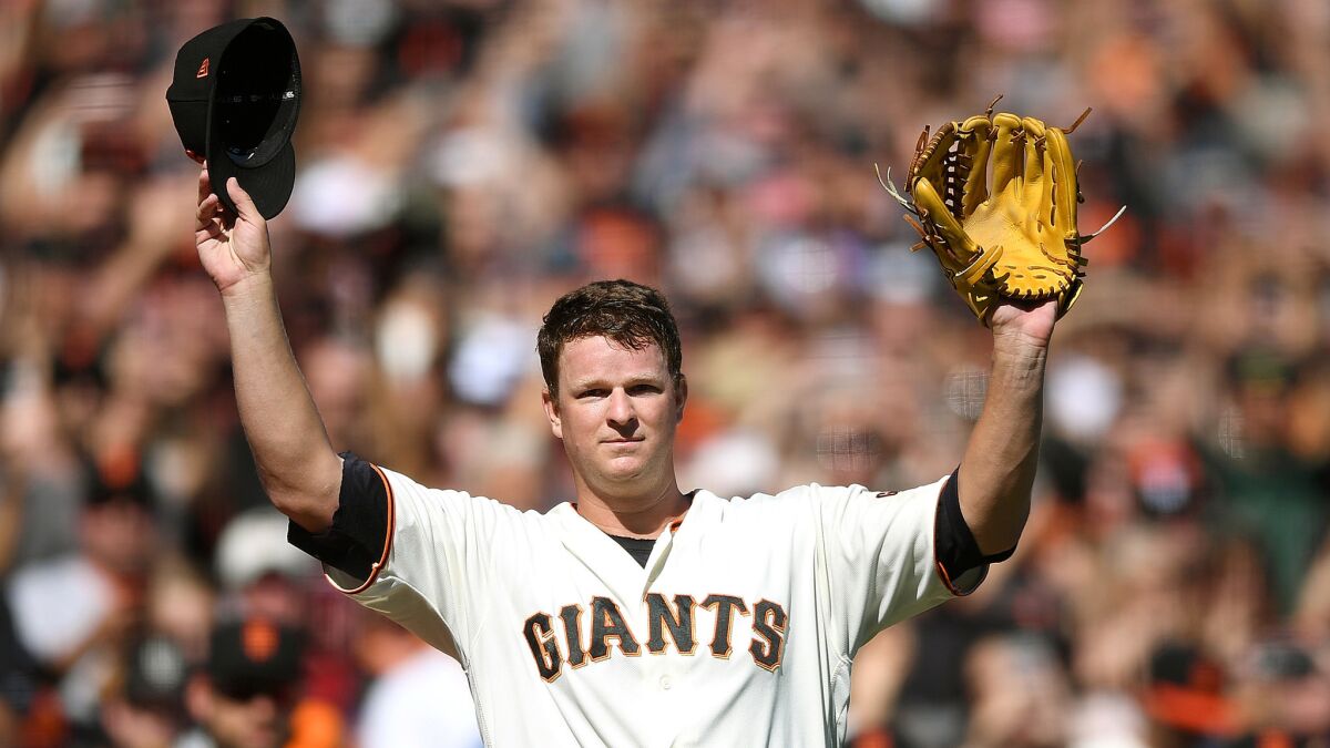 Giants pitcher Matt Cain waves to fans during Saturday's game against the San Diego Padres.