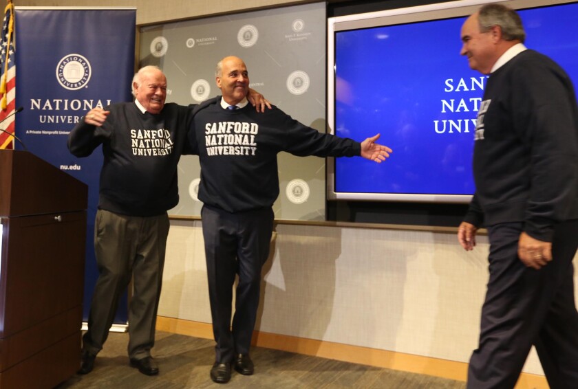 San Diego Philanthropist Denny Sanford, left, donated a record $350 million to National University and it will be renamed Sanford National University in July 2020 Dr. David Andrews, right, is President of NU and Dr. Michael Cunningham, center, is chancellor of the NU system. The gift was announced during a presentation on Tuesday, October 8, 2019.