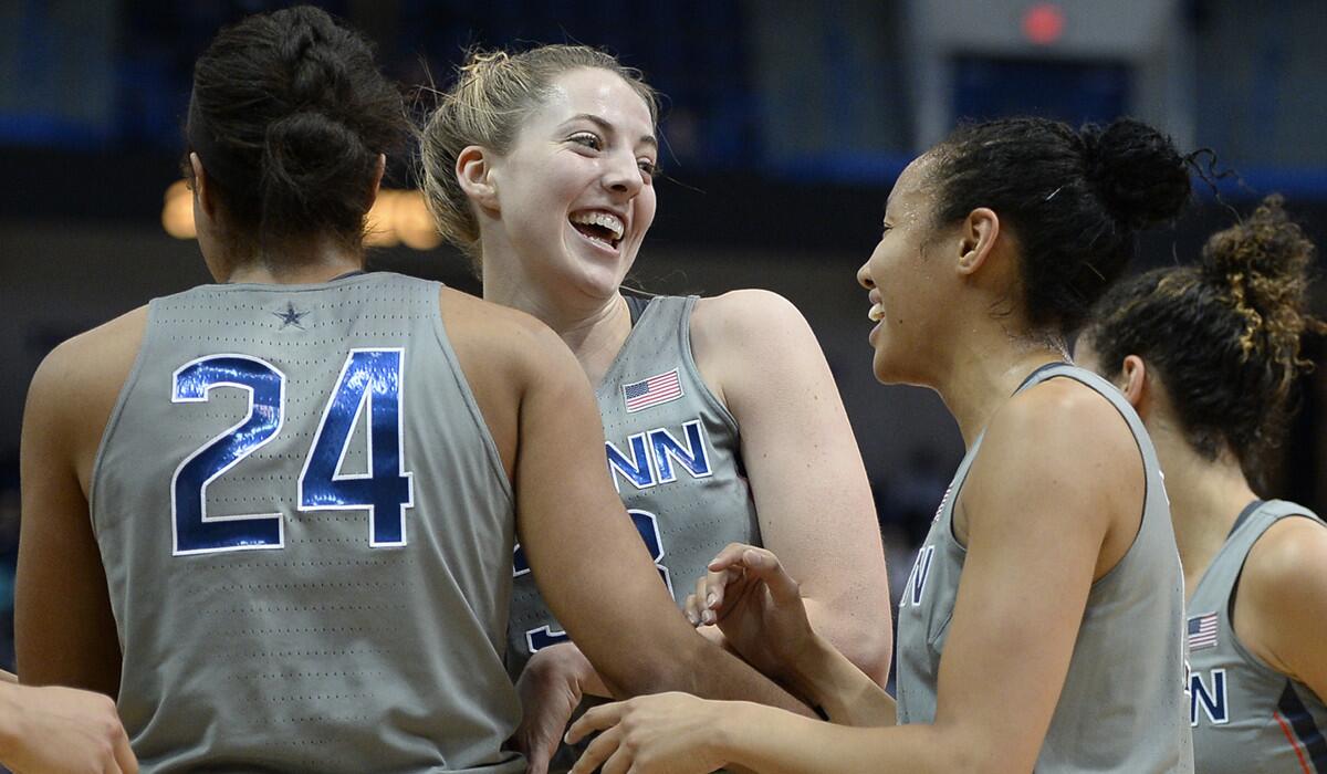 Connecticut's Katie Lou Samuelson, center, celebrates with teammates Napheesa Collier, left, and Saniya Chong, right, in the first half against South Florida on Tuesday.