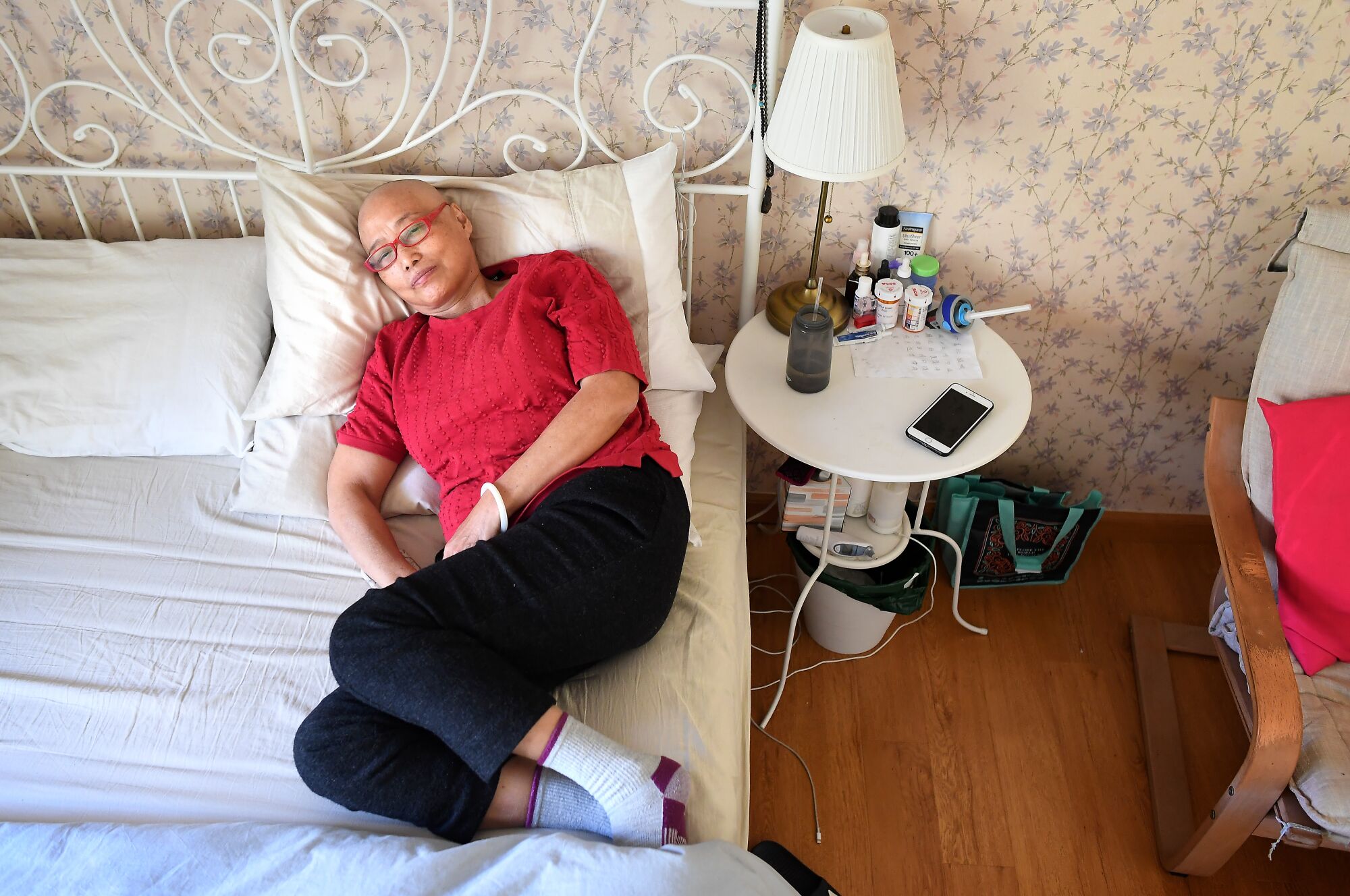 Yuyuan Lin, 63, rests in bed at her daughters house in Bradbury.