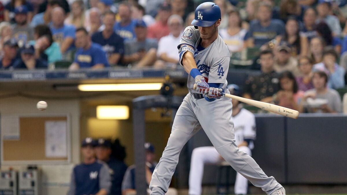 Dodgers' Cody Bellinger hits a triple in the fifth inning against the Milwaukee Brewers at Miller Park on Sunday.