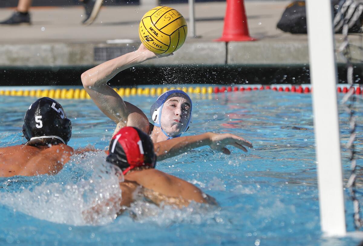 Corona del Mar's Carson Simonson takes aim on an open cage for a goal during the water polo season opener against Foothill.