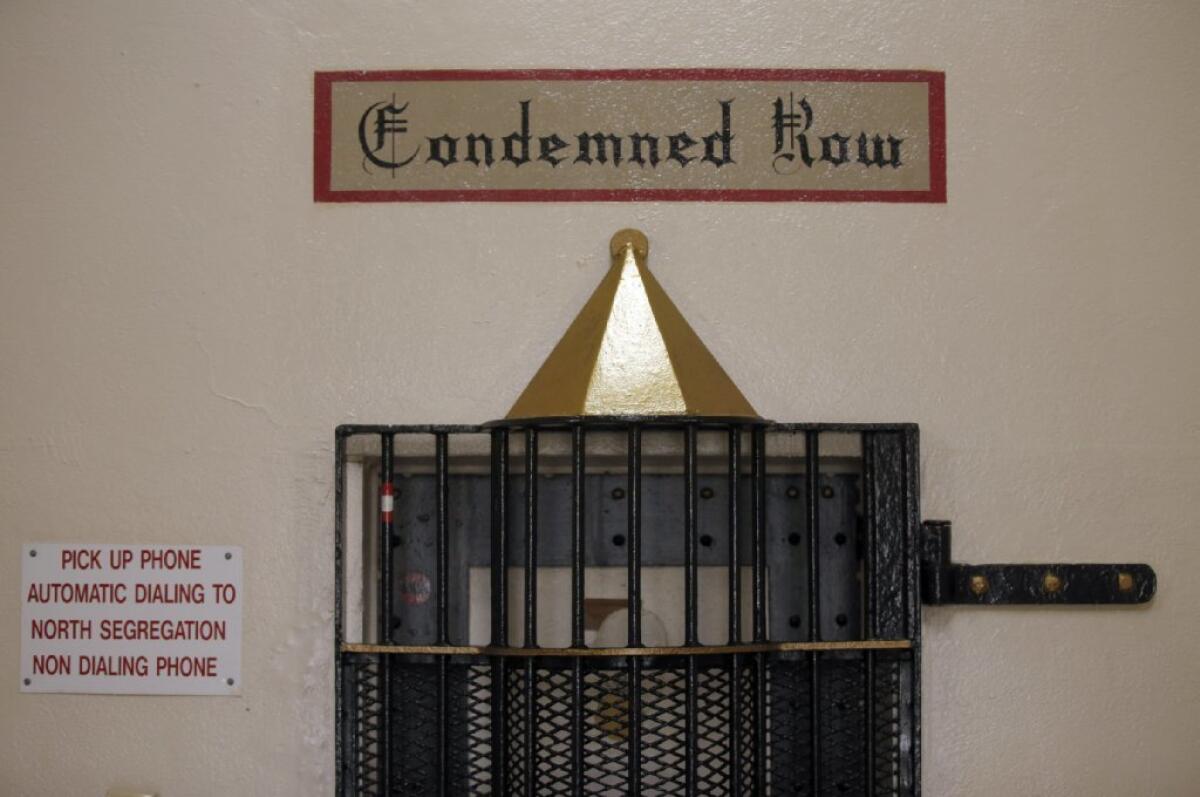 The doorway to death row in the North Segregation Unit at San Quentin State Prison is notable for a rounded metal jail door and a sign that clearly marks its purpose.