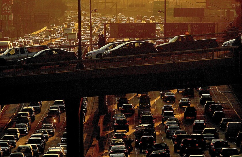 Traffic jams the 110 Freeway and downtown streets as commuters make their weekend and Christmas holiday getaway on Dec. 20, 2013.
