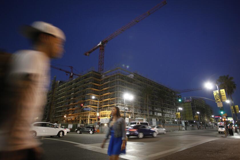 Pedestrians walk by the Blvd6200 project in Hollywood.