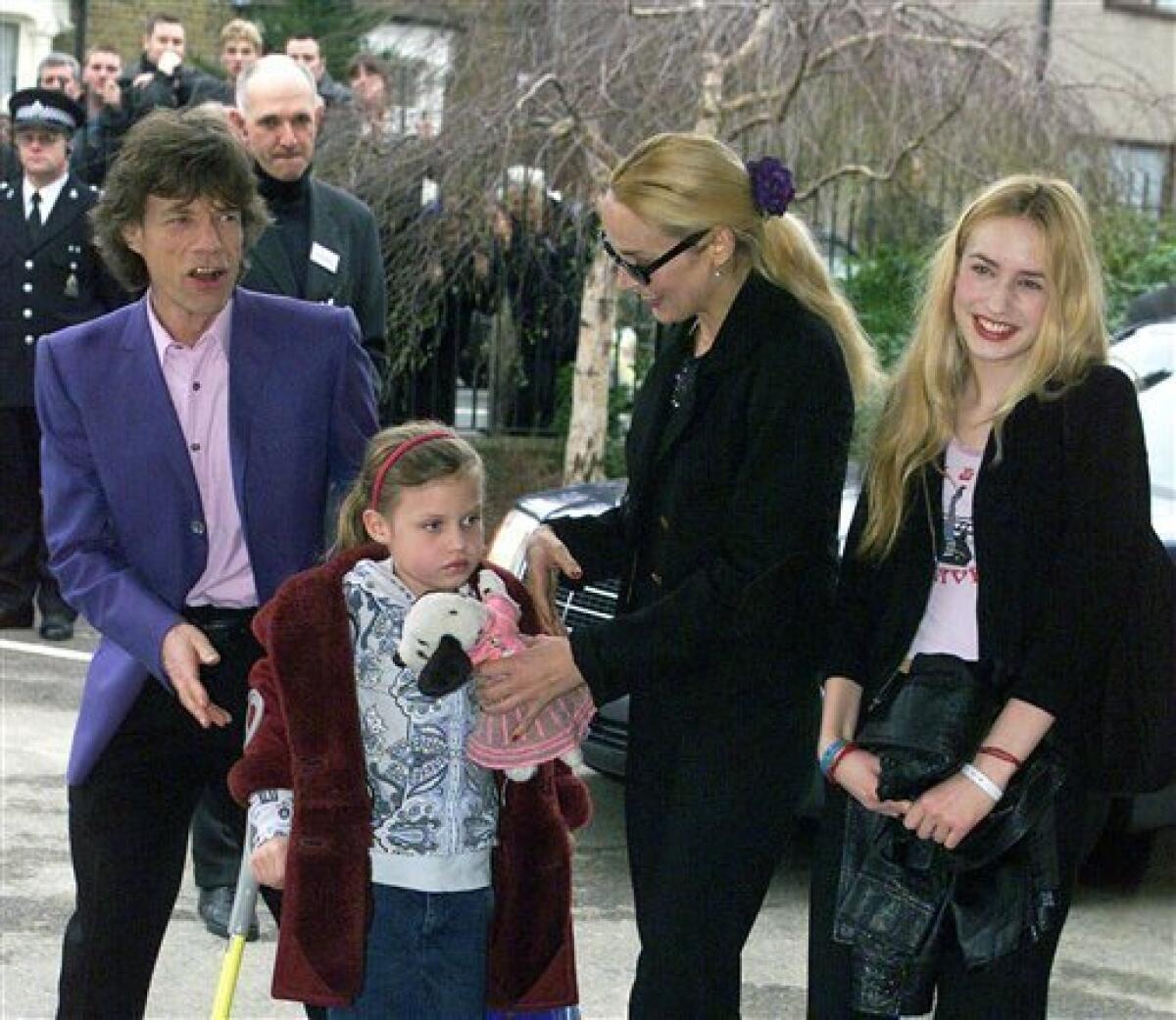 FILE - This March 20, 2000 file photo shows British pop star Mick Jagger arriving at his old school in Dartford, east of London, to open a new music center with his former wife Jerry, second from right, and children, Elizabeth, right, and Georgia, at front. Jagger is the new spokesmodel for Material Girl, the collection designed by Madonna and her daughter Lola. (AP Photo)