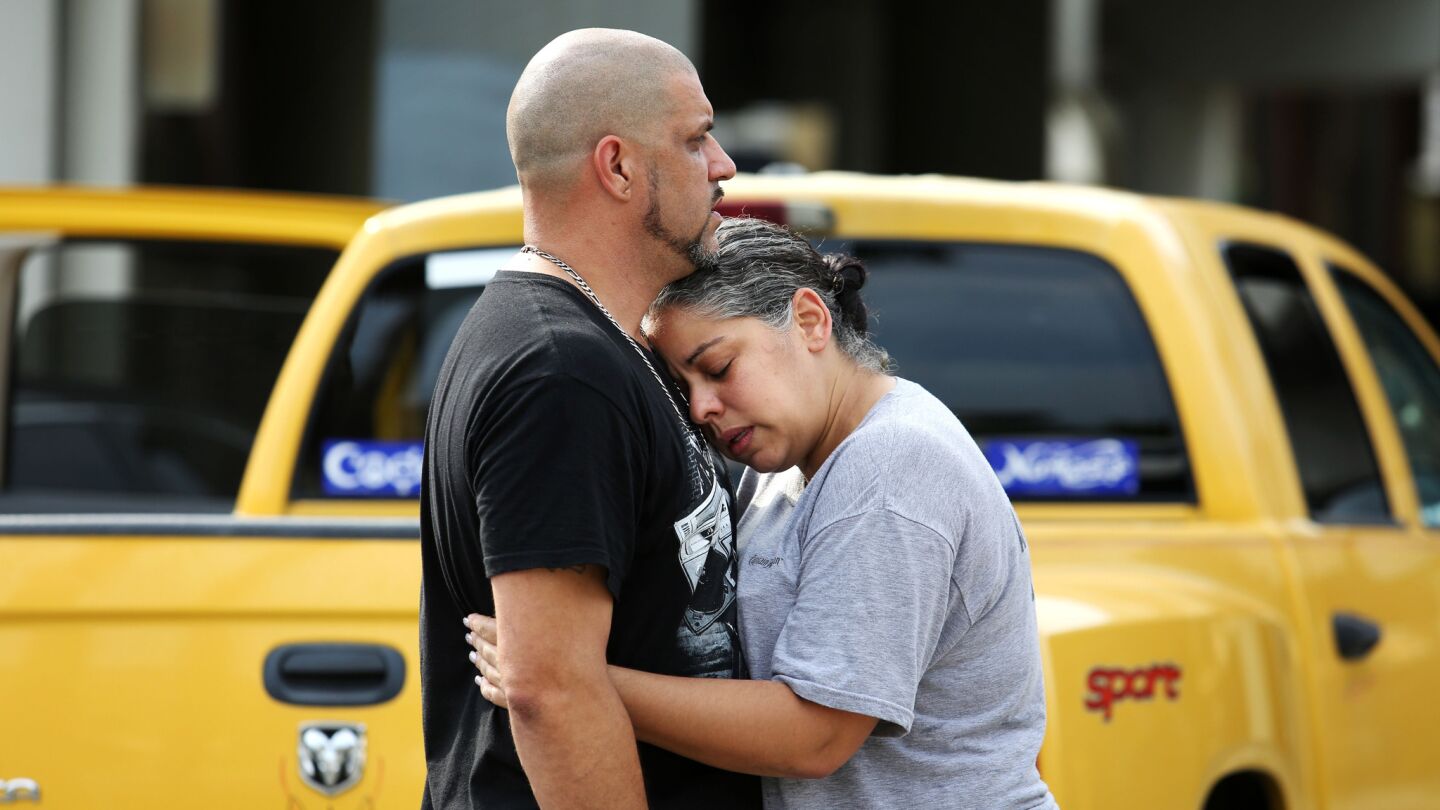 Ray Rivera, a DJ at Pulse nightclub, is consoled by a friend outside of the Orlando Police Department after 50 people were killed at the club on Sunday.