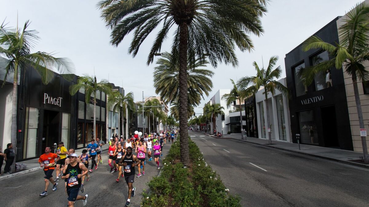 Los Angeles Marathon runners make their way along Rodeo Drive in Beverly Hills on March 15, 2015.