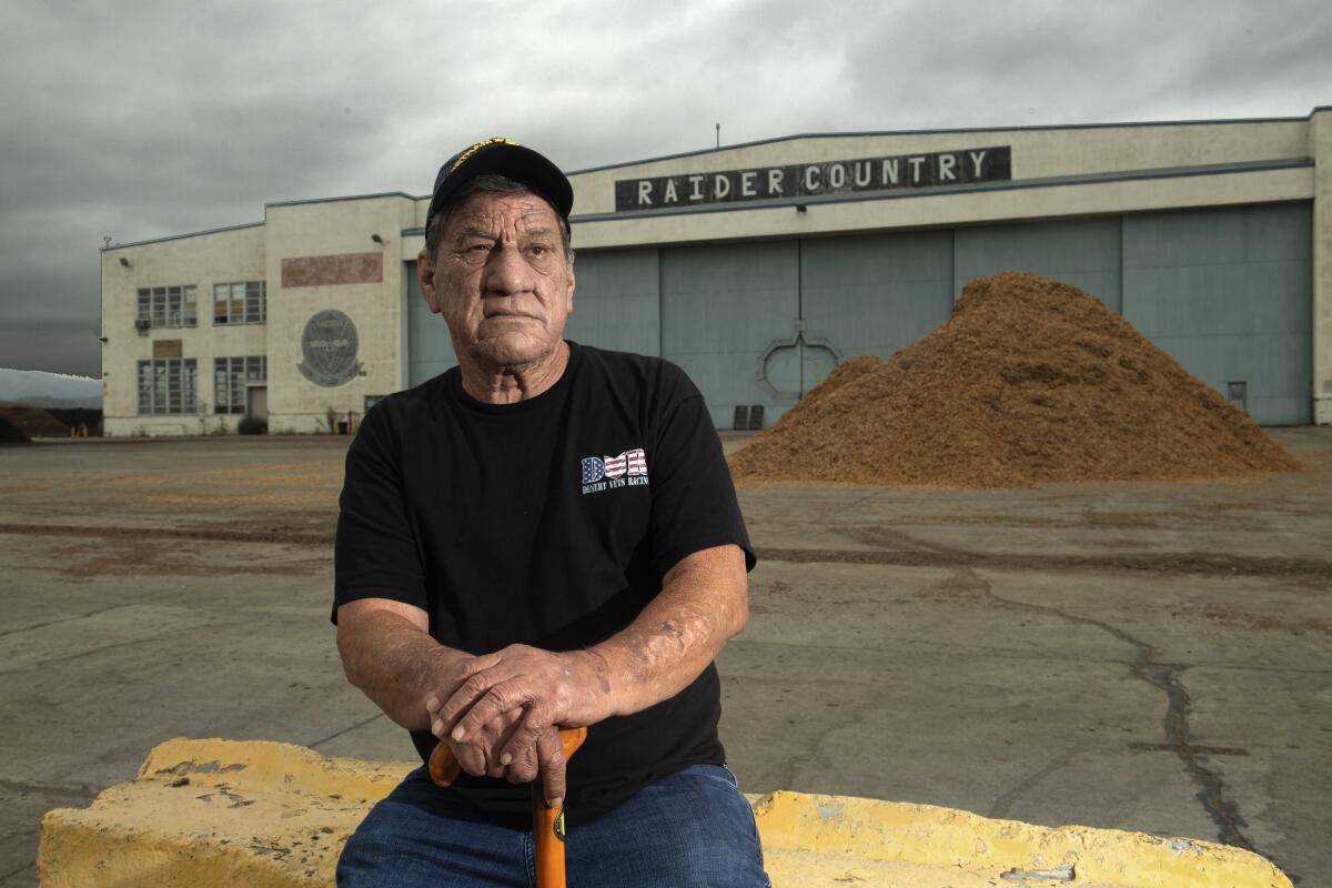 Retired Marine Corps Maj. William Mimiaga sits outside the former Hangar 296.