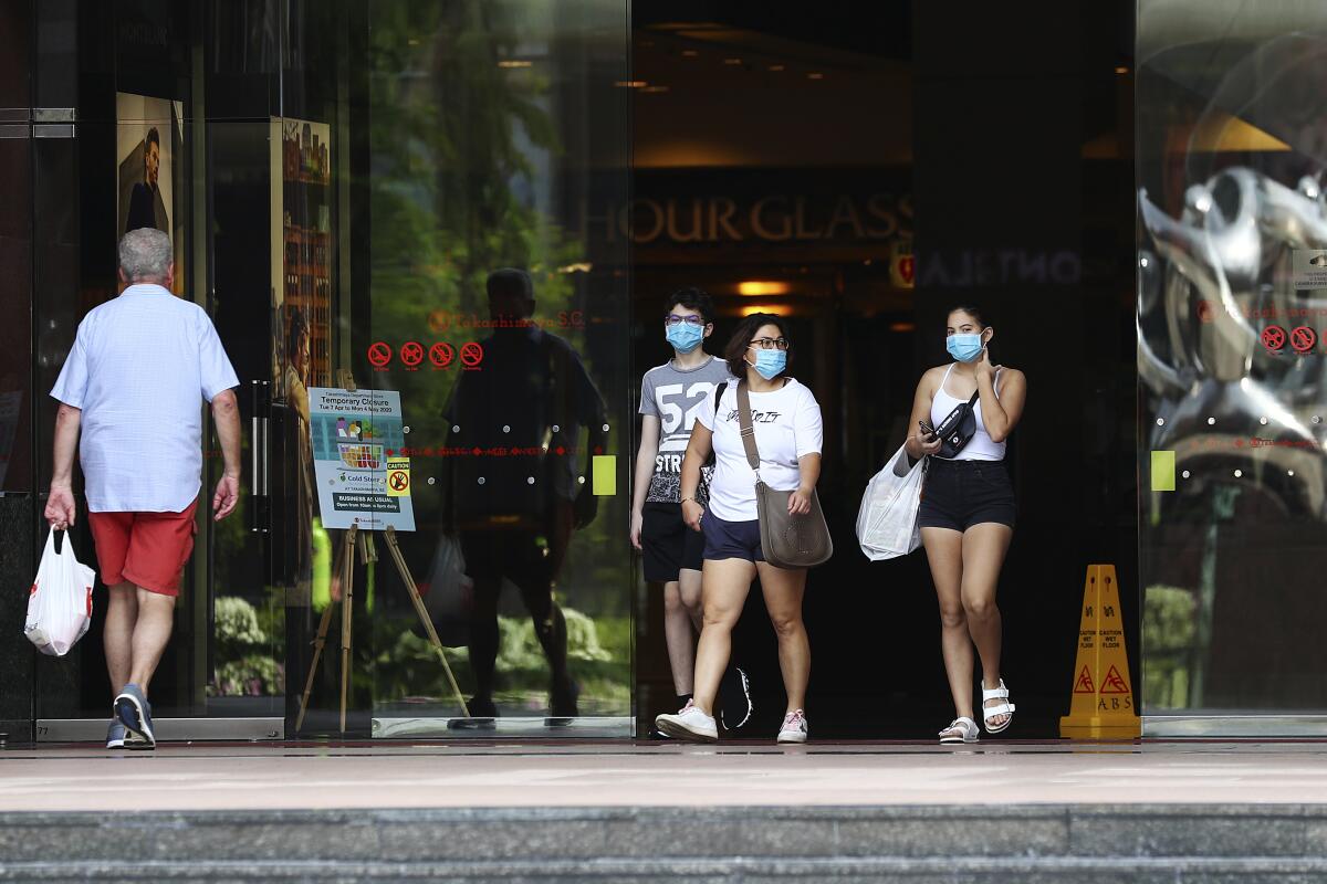 Shoppers leave a mall along Singapore's Orchard Road in April.