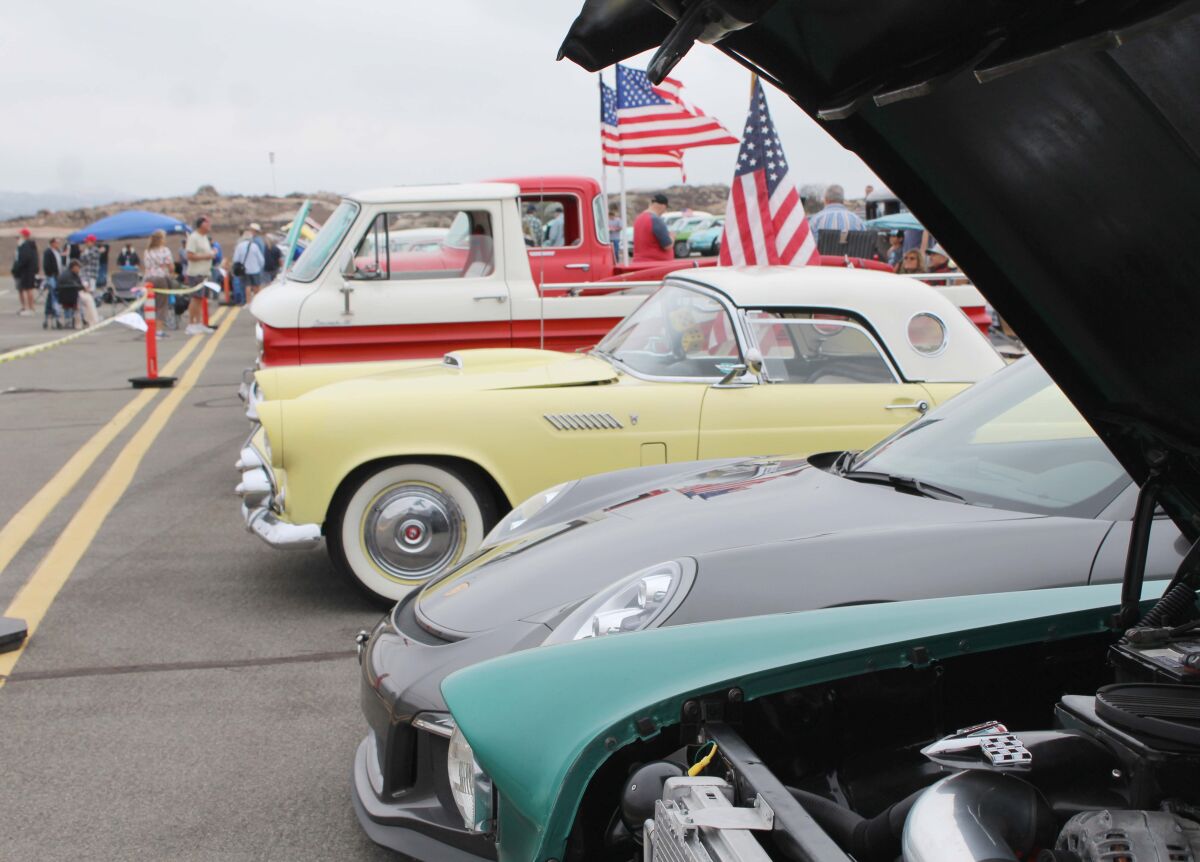 Vehicles lined up at a classic car show.