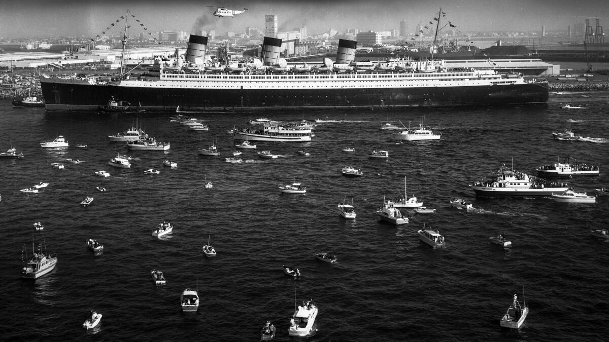 Dec. 9, 1967: A fleet of small craft join in the celebration as the 81,000-ton Queen Mary arrives in Long Beach.