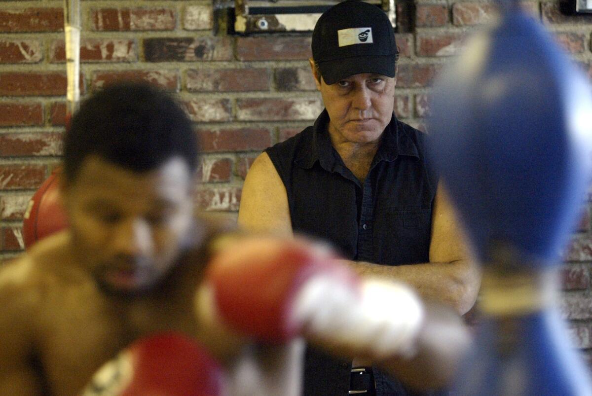 Boxing trainer Joe Goossen watches closely as Shane Mosley works out before a fight on Nov. 15, 2004. Goosen's brother, Dan Goossen, died Monday due to complications from liver cancer.